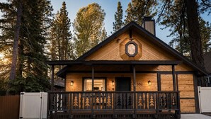 A wooden cabin with a porch, a chimney, and a number '332' on the wall. - Maverick`s Cabin - HotTub, GameRm, Firepit, fenced (Big Bear)