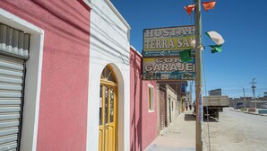 A building with a yellow door and a sign advertising a garage.