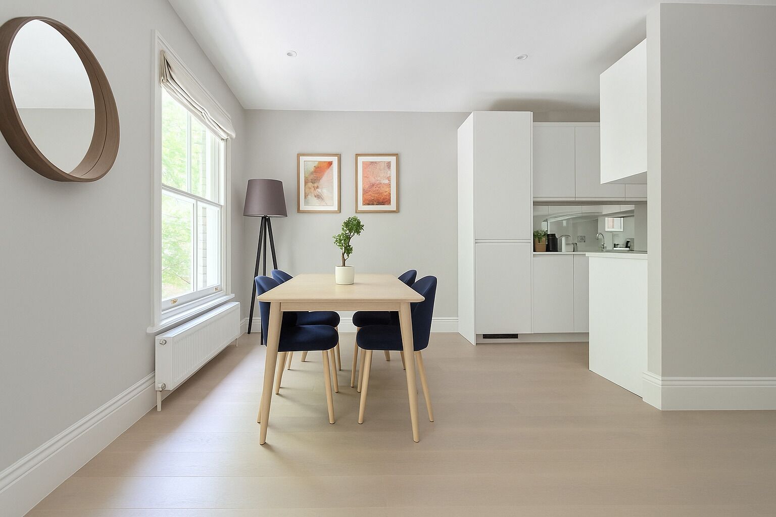A modern kitchen with white cabinets and a built-in oven.