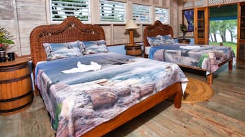 A room with two wooden beds, a wicker headboard, a wooden floor, and a view through the window.