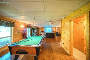 A pool table in a room with wooden walls and a ceiling fan. - Spacious Lodge @Madawaska |Ideal for Groups|Trails (Lake Saint Peter)