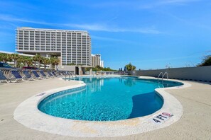 A swimming pool with a 4 FT depth marker, lounge chairs, and a hotel building in the background. - $150 Free activities - E-gift card when you book- On the ocean | SH105-1 (Myrtle Beach)
