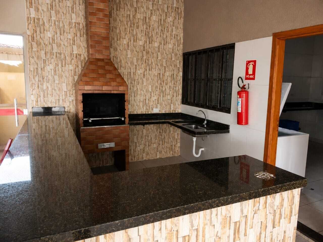 A kitchen with a built-in stove, a sink, and a fire extinguisher.