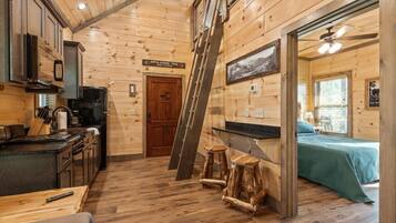 Kitchen and loft ladder with bedroom beyond