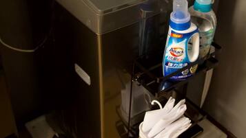 A self-service beverage dispenser with a bottle of hand soap and a bottle of hand sanitizer.