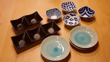 A variety of ceramic bowls and plates on a wooden table.