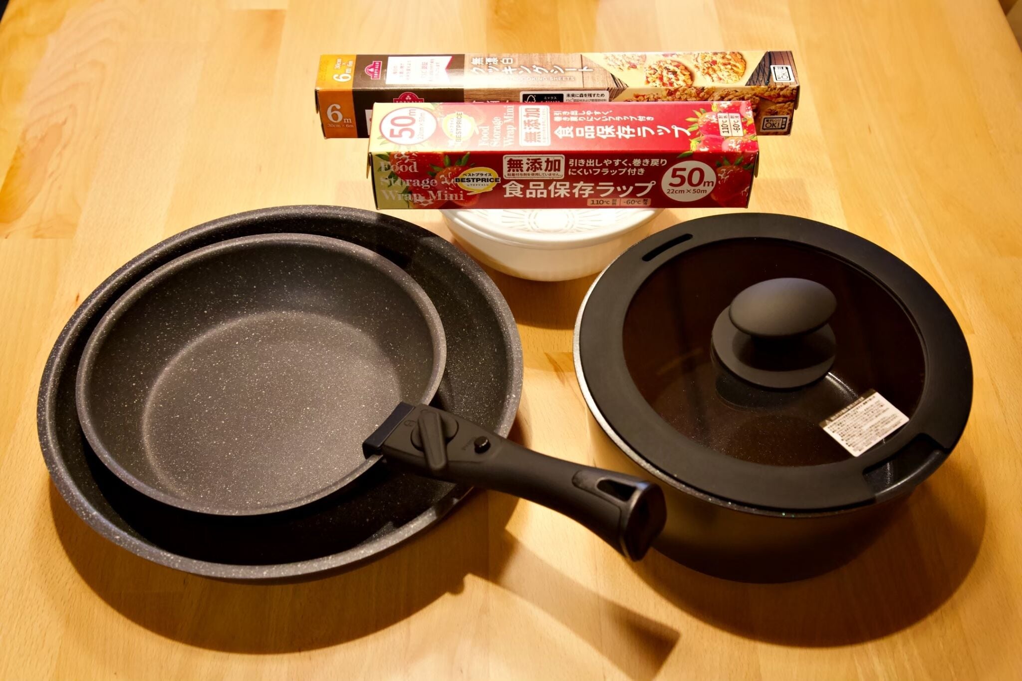 A kitchen with a frying pan, a pot, and some packaged food items.