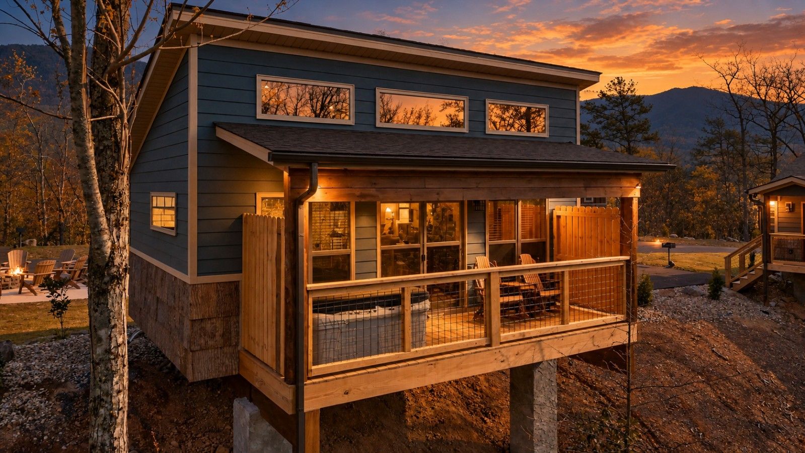 A two-story house with a balcony, a deck, and a view of the surrounding landscape.