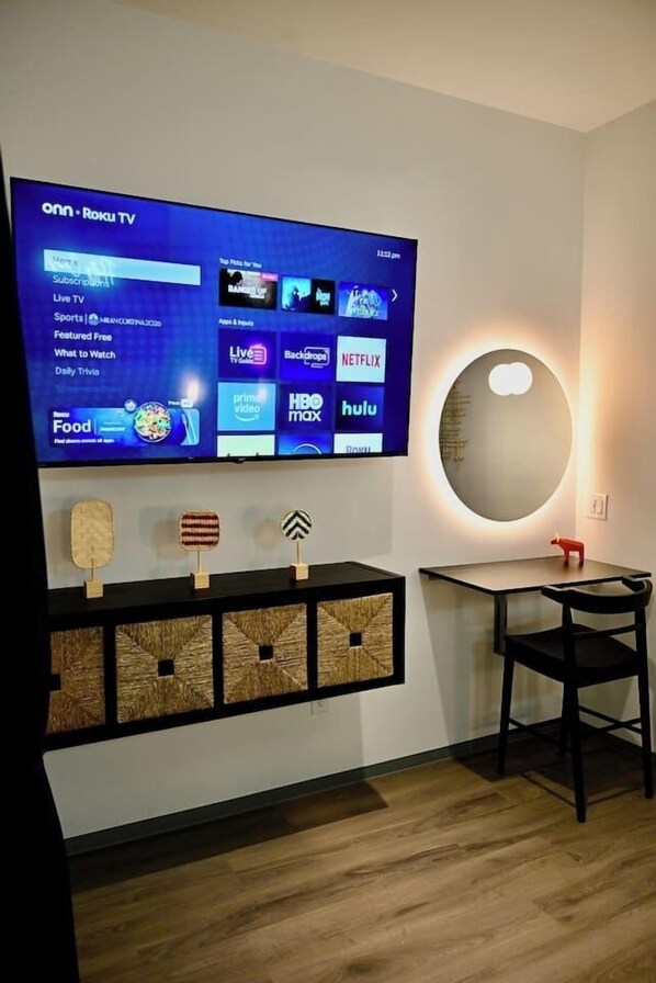 A flat-screen TV mounted on a wall displaying a streaming service interface.