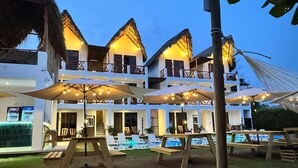 A resort with multiple levels, outdoor seating, and a pool area.