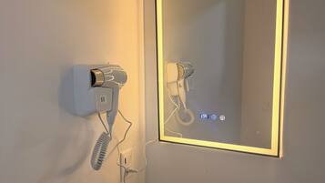 Shower, hair dryer, towels, toilet paper