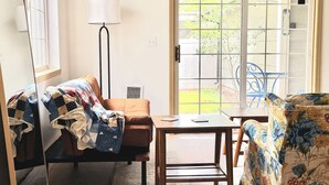A room with a sofa, a table, a lamp, and a window with a view of the outside. - 2-bedroom/2bath condo near downtown Spokane (Spokane)