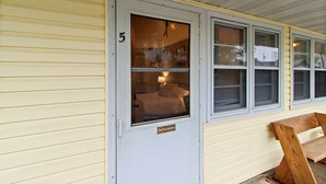 A room with a bed, a 'NO SMOKING' sign, and a window with blinds. - Room 5, Kozy Rest Motel (Montello)