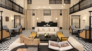 A hotel lobby with a central seating area, a black coffee table, and a sofa. - Aura Opera House Chinatown- Newly Renovated (Singapore)