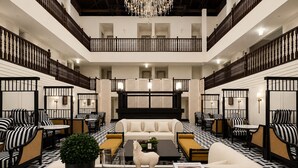 A spacious lobby with a central seating area, a chandelier, and a piano. - Aura Opera House Chinatown- Newly Renovated (Singapore)