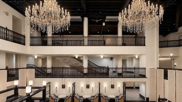 A multi-level hotel lobby with chandeliers, a staircase, and seating areas. - Aura Opera House Chinatown- Newly Renovated (Singapore)