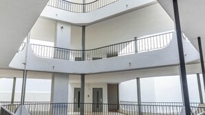 Un interior de varios niveles con balcones y escaleras.