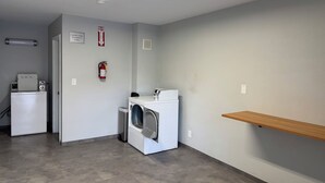 A laundry room with a washing machine, dryer, and a fire extinguisher on the wall. - Pet-Friendly Unit Perfect for Exploring Vancouver’s Local Attractions (Clark County)