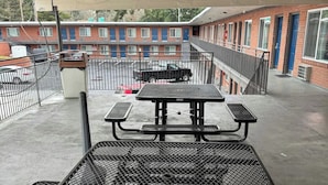 A rooftop patio with a picnic table and a metal grill. - Smart Choice for Budget-Conscious Travelers Near Dinings | City Sandwich -0.1 mi (Clark County)