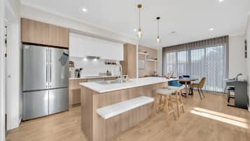 Coffee/tea maker, fridge, dishwasher, dining tables
