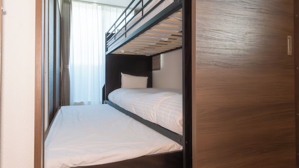 A bunk bed with a wooden headboard and a lower bed. - Kag.R Ohori 3  (Fukuoka)