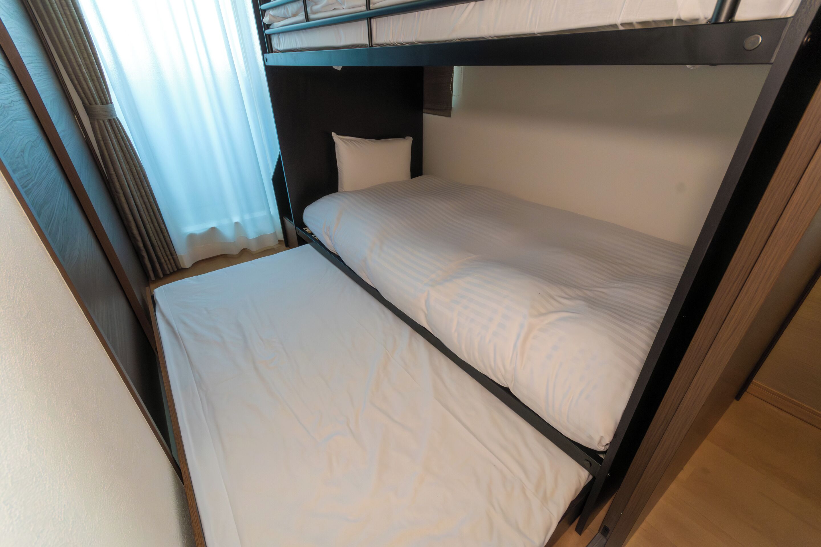 A bunk bed with a pillow and a headboard.