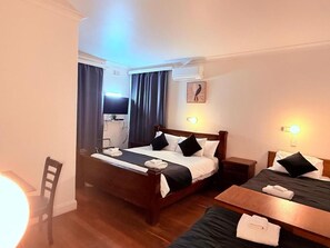 A hotel room with a bed, bedside tables, a desk, and a chair. - Coonalpyn Hotel (Coonalpyn)