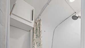A bathroom with a toilet, a shower, and a bathtub. - Vintage Motorhome Stay | Unique Experience | Cañon City, CO (Canon City)