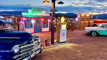 A vintage-themed area with a neon sign for 'Starlite Vintage Resort,' a vintage gas pump, and classic cars.