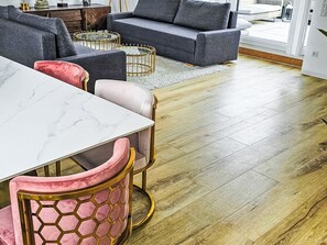 A modern living room with a marble table, a sofa, a coffee table, and a patterned chair. - Luxus 80m² Dachgeschoss City Wohnung by Interhome (Munich)