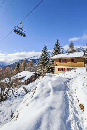 A snow-covered mountain landscape with a wooden building and a ski lift. - La Marmotte by Interhome (Bellwald)