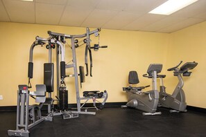 A gym with various exercise equipment including a squat rack, a bench press, and an elliptical machine. - Amazing OceanView•14th-Fl• Spacious 3BR •Fireplace •Pool• Sleeps 10 (Myrtle Beach)