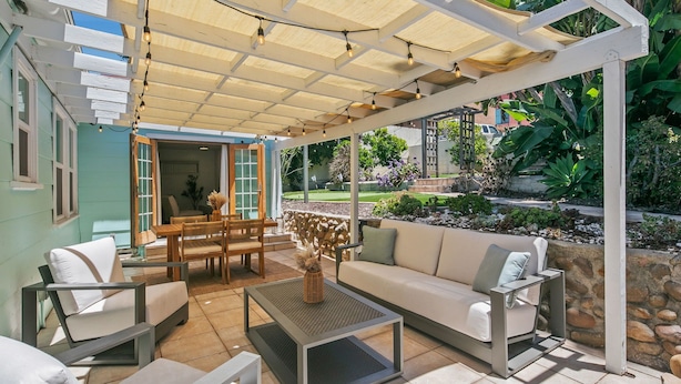 A covered outdoor seating area with a table, chairs, and a sofa. - Charming retreat with AC and outdoor oasis, just 3 blocks from Lafayette Hotel (San Diego)