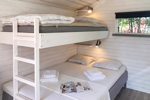 A bunk bed room with a ladder, a window with a view, and a magazine on the lower bunk. - Skummeslöv Beach Home B, Skummeslövstrand, Sweden (Skummeslövstrand)