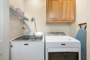 A laundry room with two Maytag washers and dryers, a wooden cabinet above, and a towel rack with a patterned towel. - Historic & Modern, Two Hot Tubs, Great For Groups, Central Courtyard (Sedona)