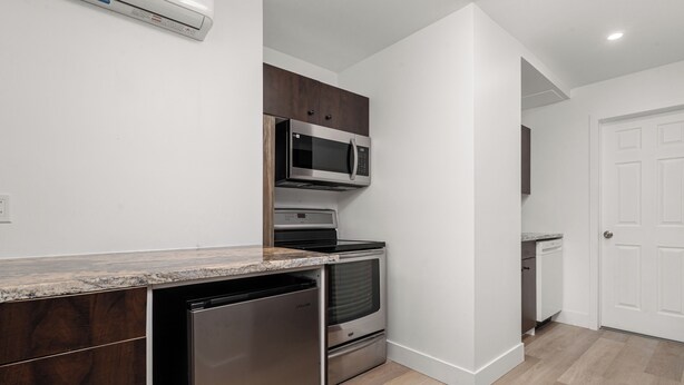 A modern kitchen with built-in appliances, a dishwasher, and a microwave.