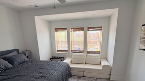 A bedroom with a bed, a ceiling fan, a window seat, and a view of the outside. - 2-bed apartment in vibrant South Phila neighborhood walking distance to stadiums (Philadelphia)