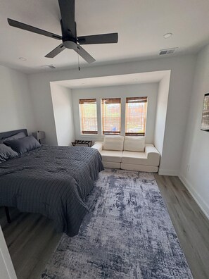 A bedroom with a bed, a ceiling fan, a window seat, and a view of the outside. - 2-bed apartment in vibrant South Phila neighborhood walking distance to stadiums (Philadelphia)