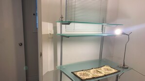 A room with a glass desk, a chair, a lamp, and a window with blinds. - Gorgeous 4-bedroom house in Vancouver perfect for your getaway (Vancouver)