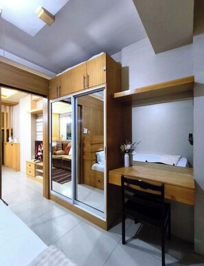A compact room with a bed, a desk, and a wardrobe. - MOA Staycation - MOA Homestay (Pasay City)