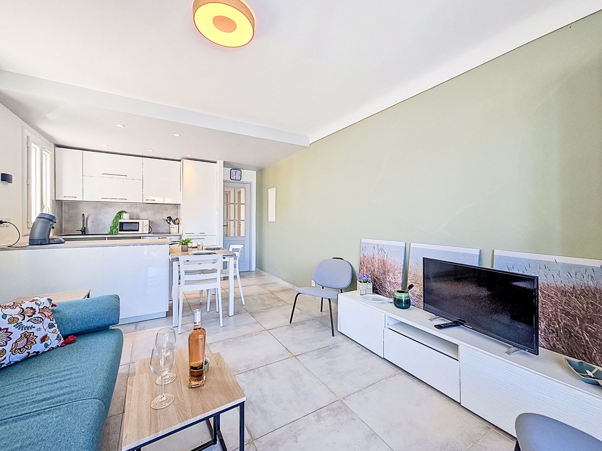 A modern apartment with a kitchen, dining area, and living room.