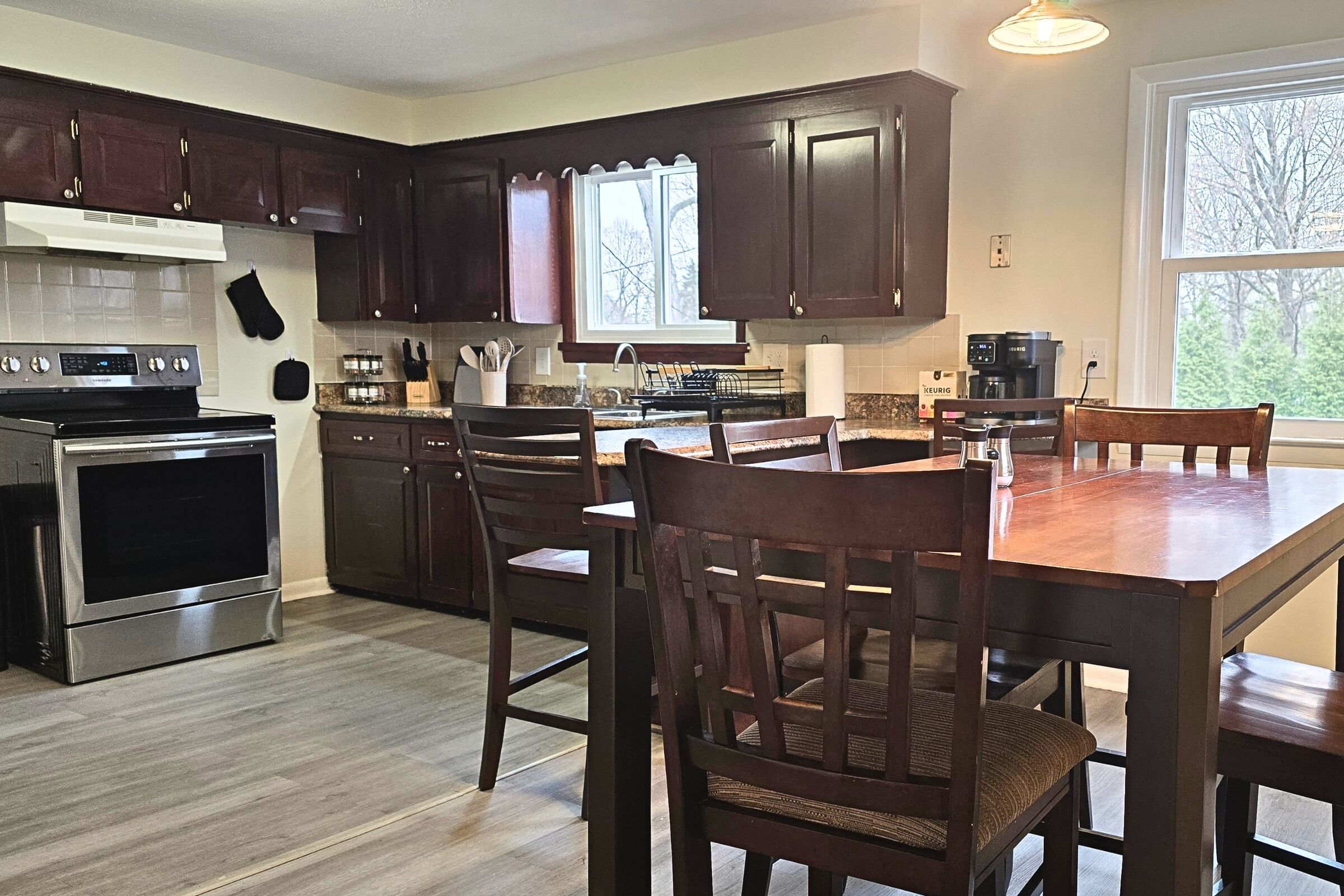 Cozy kitchen with stainless range, coffee bar, and sunny dining nook