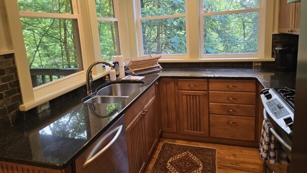 A kitchen with a sink, stove, and wooden cabinets. - Two bedroom  in United States of America, Glenville (Glenville)