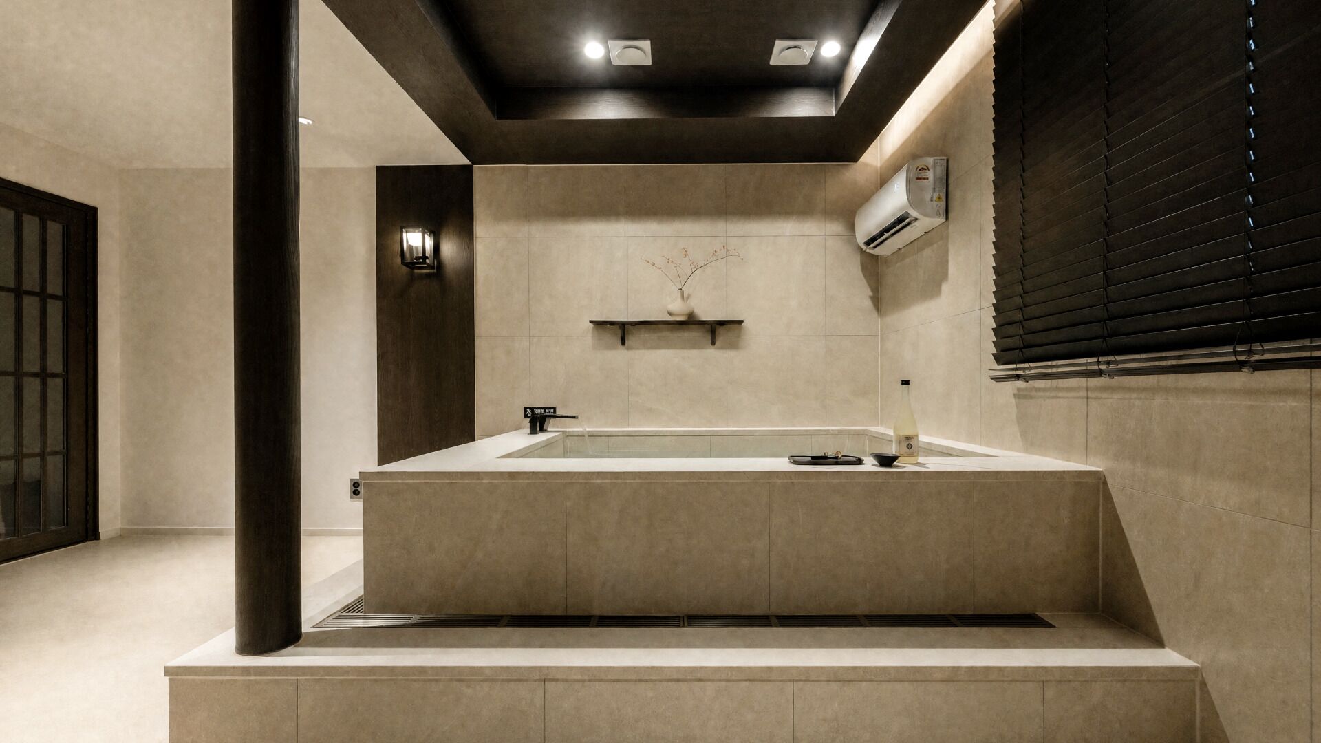 A modern bathroom with a freestanding bathtub, a towel rack, and a wall-mounted air conditioner.