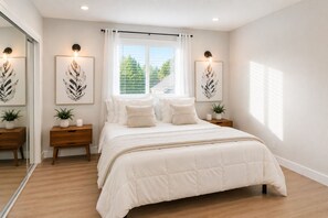 A bedroom with a bed, nightstands, a window with curtains, and wall-mounted light fixtures. - 3-bedroom house in amazing Los Angeles with AC and fitness room (Los Angeles)