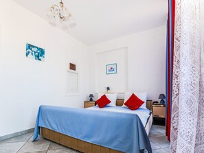 A bedroom with a bed, two nightstands, a lamp, and a ceiling light fixture. - Apartment Jako by Interhome (Trogir/Slatine)