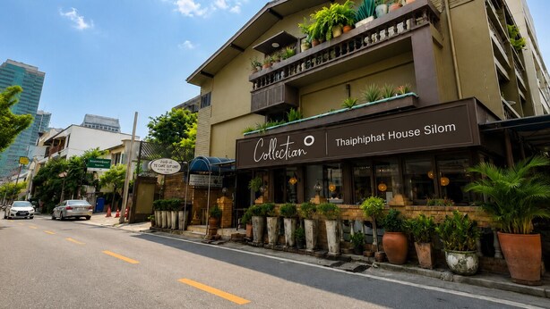 A building with a sign reading 'Collectian Thaiiphat House Silom' and balconies with potted plants. - Collection O Thaiphiphat House Silom (Bangkok)
