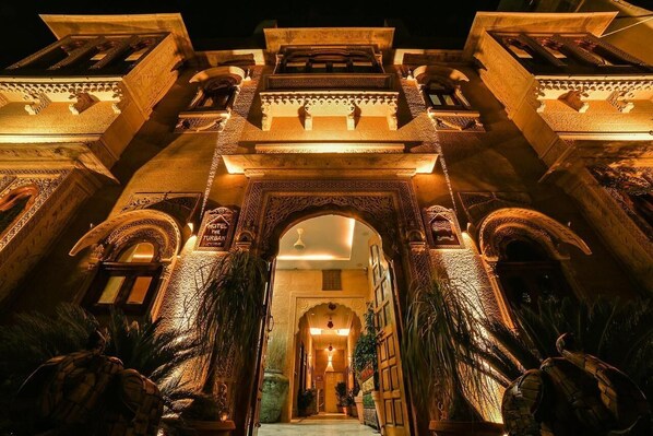 A grand entrance with intricate arches and detailed carvings, leading into a well-lit interior. - Hotel Golden Routes (Jaisalmer)
