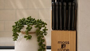 A kitchen utensil holder with black handles and a wooden label reading 'moss & stone.' - Brand-New Luxury Private ADU, 2BR/2BA, Full Kitchen & Laundry (Fountain Valley)
