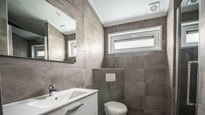 A modern bathroom with a sink, mirror, toilet, and shower. - Holiday Home in Arnhem With Terrace (Arnhem)